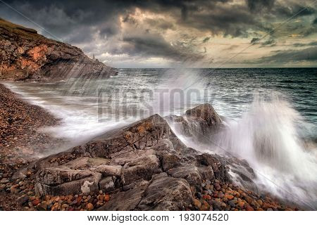 Crashing waves and storm clouds
Slow shutter speed showing the movement of a wave crashing on Bracelet Bay on the Gower peninsula, Swansea, South Wales.