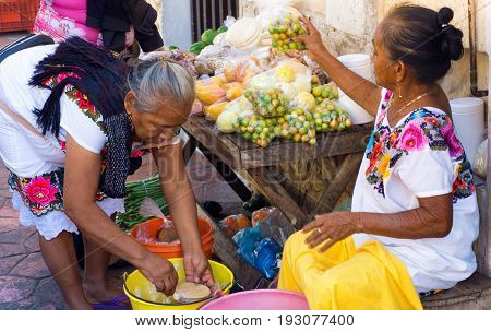 VALLADOLID MEXICO - FEBRUARY 11: Women selling fruit on the street in Valladolid Mexico on February 11 2017