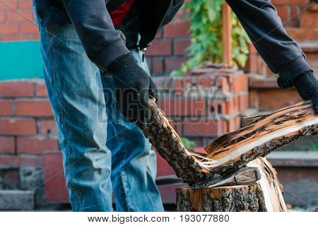 Splits Firewood The Axe. The Man Splits The Axe Wood.