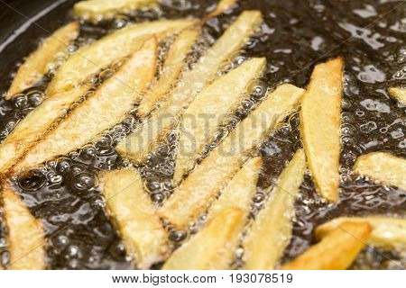 French fries fried in a pan . A photo