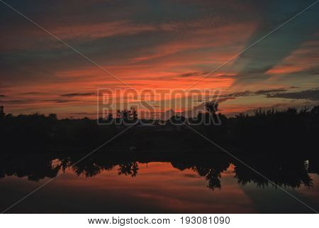 July sunset with clouds reflected in the river Hoper.