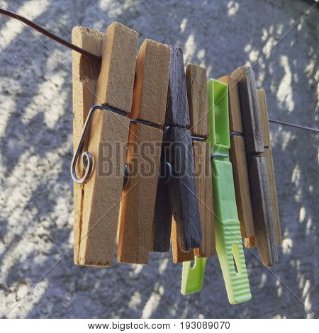 Clothespins on rope isolated on a favela background.