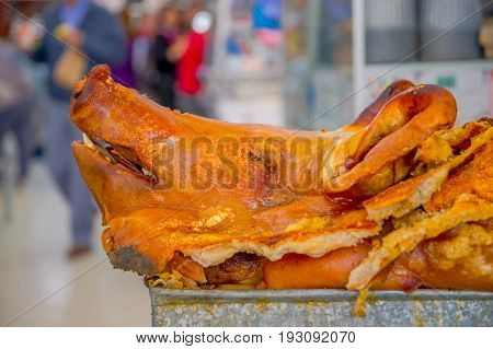 Delicious hornado roasted pork, over a silver tray, ecuadorian traditional typical andean food located in the municipal market in San Francisco in the city of Quito.