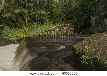 Dolsky mill in national park with old ruin of mill in north Bohemia