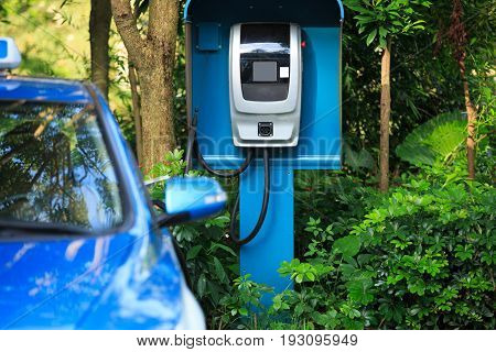 closeup of electric car charging at station