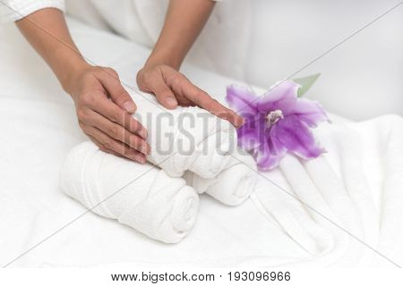 Hands of happy woman setting spa or wellness welcome decoration in spa salon background Healthy lifestyle and relaxation concept