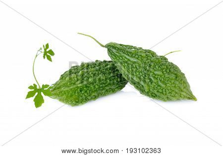 whole raw bitter gourd with leaf on white background