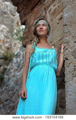Young Blonde Woman With Braided Hear  Wearing Turquoise Dress