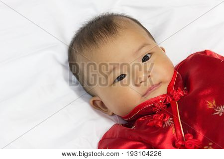 Asian cute new born girl baby with gesture of congratulation happy chinese new yeras.