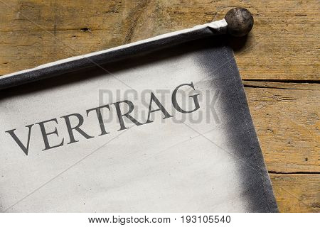 Old Scroll On Wooden Table, German Word, Concept Contract