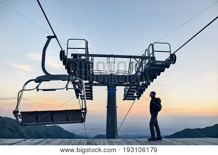 Tourist Near Cable Car In The Mountains