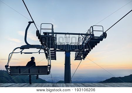Tourist Near Cable Car In The Mountains