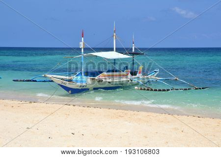Puka beach, Boracay island, The Philippines - March 2016.
The local  philippines boat on the Puka beach.