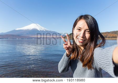 Young Woman travel in Fuji and taking selfie