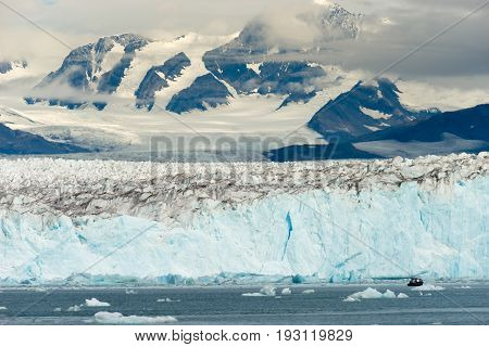A small boat tries to navigate the icebergs in Kenai Fjords