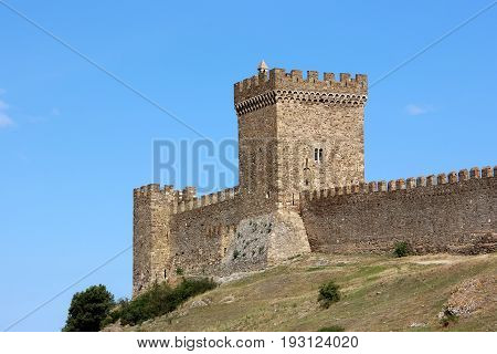 Tower with battlements in the Genoese fortress the Consular castle. The medieval fortress in Sudak in the Crimea.