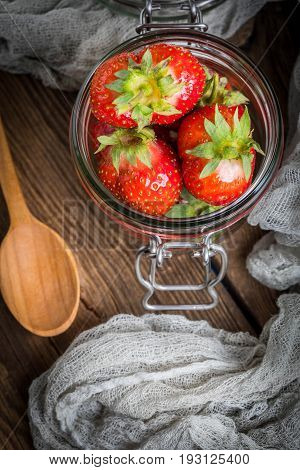 Strawberry In Jar On Wooden Background.