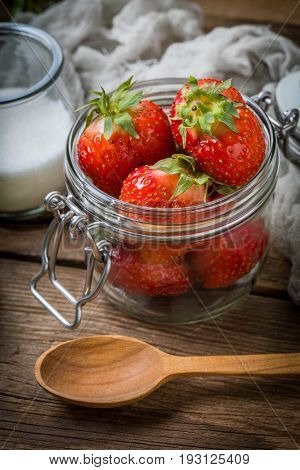 Strawberry In Jar On Wooden Background.
