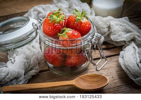 Strawberry In Jar On Wooden Background.