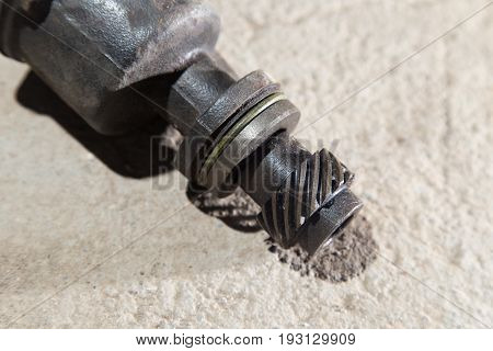 The part from the car lies on the concrete