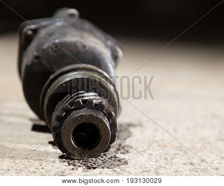 The part from the car lies on the concrete