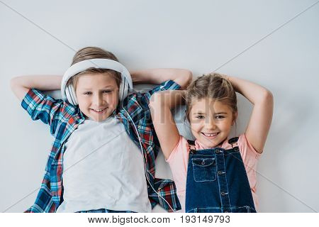 Adorable Pre-adolescent Kids Looking At Camera With Hands On Head