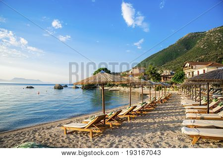 Beautiful beach with chairs and unbrellas in Nikiana village, Lefkada - Greece