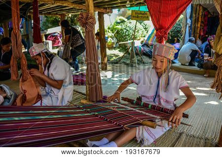 CHIANGMAI THAILAND - JANUARY 24 2015: Hill tribe girl is demonstrating weaving in 22nd Traditional Skirt Fabric and The Indigenous Product and Culture Festival in Mae Chaem of Chainagmai Thailand