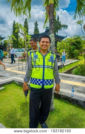 BALI, INDONESIA - MARCH 08, 2017: Unidentified man posing in traditional balinese hindu temple Bajra Sandhi monument in Denpasar, Bali, Indonesia on background tropical nature and blue summer sky, Indonesia.