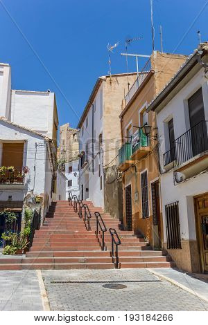 BUNOL, SPAIN - JUNE 13, 2017: Colorful street and steps leading to he castle of Bunol, Spain