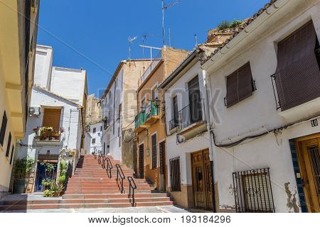 BUNOL, SPAIN - JUNE 13, 2017: Colorful street and steps leading to he castle of Bunol, Spain