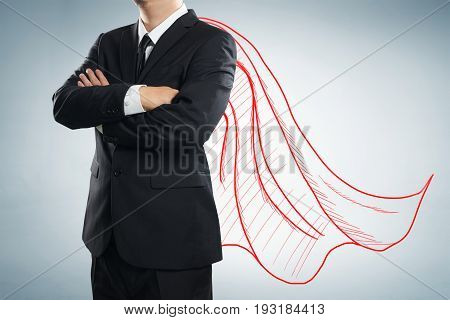 Businessman with drawn red color cape. the concept of success leadership and victory in business.