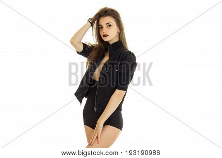 Cute young girl in black jacket and high panties without bra under posing on camera isolated on white background