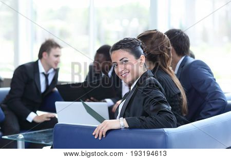 Young business woman standing with her co-wokers in background
