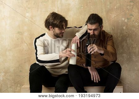 Two Friends In Casual Wear Cheering Bottles