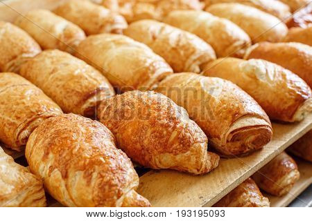 Puff pastry on wooden board. morning at the bakery. Lots of baked products. Income of cafe is growing. Dough with filling.