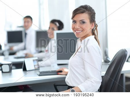 Young business woman standing with her co-wokers in background