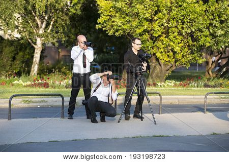 BUDAPEST, HUNGARY. 23 JUNE, 2017: A group of wedding photographers on the streets of Budapest is holding a photo session for a couple of newlyweds.