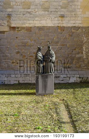 MAASTRICHT NETHERLANDS - JANUARY 16 2016: Statues of Monulfus and Gondolas Maastricht bishops in front of Basilica of St. Servatius by sculptor Jef Courtens. The Basilica of St. Servatius is a oldest Roman catholic church the Netherlands.