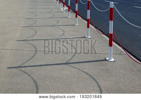 PAVEMENT - Barriers on the sidewalk and asphalt roadway