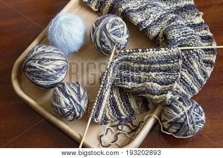 Balls of wool and knitting needles on the table