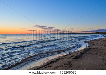 Waves On The Shore Of Ladoga Lake At Dawn. Beautiful Sunrise Landscape.