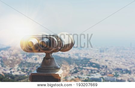 Touristic telescope look at the city with view of Barcelona Spain close up old metal binoculars on background viewpoint overlooking the mountain hipster coin operated in panorama observation mockup