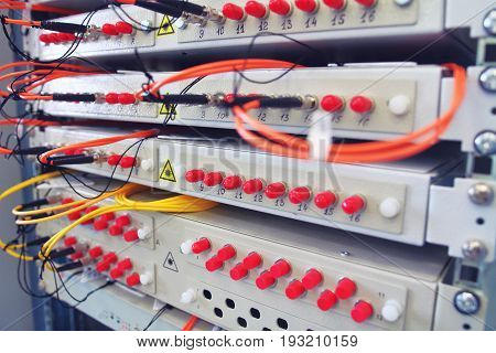 Fiber optical switch with connected FC cables in server room. Communication equipment opto cable. Optical fibre information technology equipment in data center