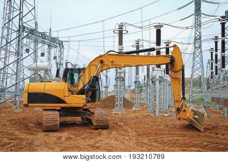 Crawler excavator at construction site of electrical substation of industrial sector. concept of industrial construction.