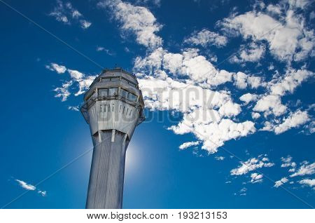 Airport traffic control tower with background of the sky and clouds