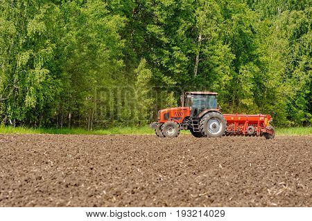 Farmer Seeding Crops At Field
