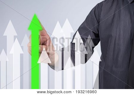 Sales Growth Graph - Businessman hand pressing button on touch screen interface. Business technology internet concept. Stock Photo
