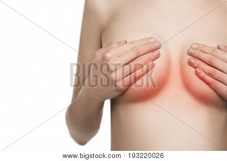 nude Female breast. Young caucasian adult woman examining her breast for lumps or signs of breast cancer with red sign of disease.