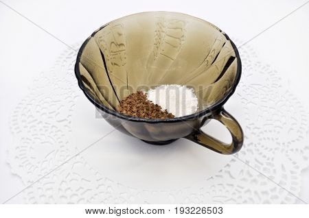 black glass small Cup on a white Lacy napkin on a white background